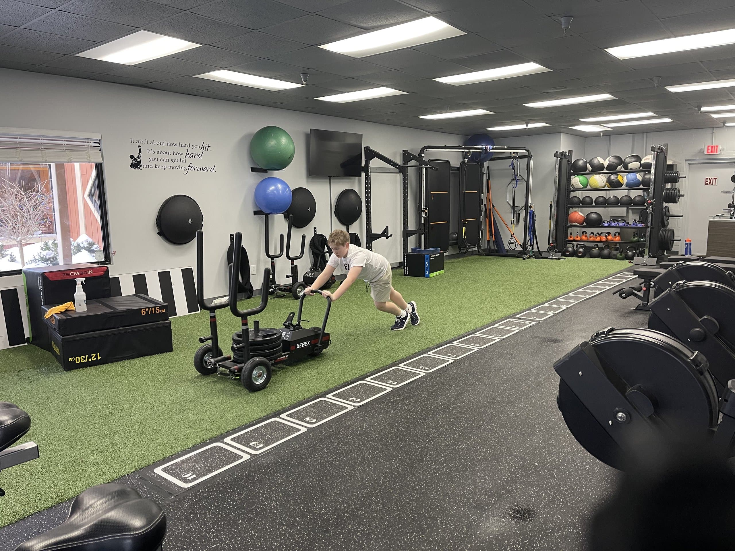 A member pushing a weighted sled during a private training session at 838 Strength and Fitness in Monroe, CT