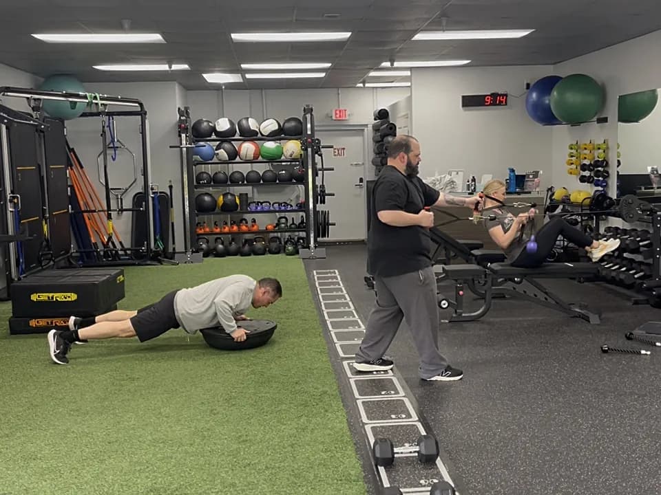 A coach working with members during a semi-private session at 838 Strength and Fitness
