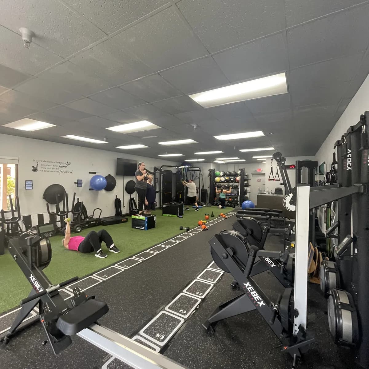 A coach working with members during a semi-private session at 838 Strength and Fitness in Monroe, CT